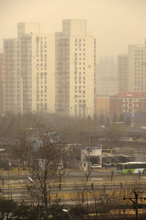 Towering buildings in the city proper are hazed by floating dust, as the first 'yellow dust' storm of this year shrouds the urban areas after northerly wind blew in sand from drought-hit northern China exacerbating the yellowish sky, in Beijing, March 15, 2009. The sand came from Inner Mongolia Autonomous Region, Gansu and Qinghai provinces, where sandstorms raged earlier this week after prolonged drought, according to the Central Meteorological Bureau. [Wang Huaigui/Xinhua] 