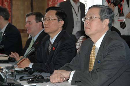 Chinese Finance Minister Xie Xuren (2nd R) and Zhou Xiaochuan (R), governor of the People's Bank of China, China's central bank, attend the opening ceremony of the G20 Finance Ministers' meeting at a hotel near Horsham in southern England March 14, 2009.[Xinhua]
