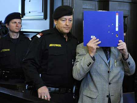 Defendant Josef Fritzl covers his face prior to the start of his trial for incest on Monday, March 16, 2009, at the provincial courthouse in St. Poelten, Austria. The trial has started Monday in Austria for Fritzl, accused of imprisoning his daughter for 24 years and fathering her seven children.[Xinhua/AFP]