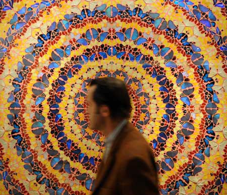 A man passes an artwork made up of butterflies during the 22nd European Fine Art Fair TEFAF Maastricht 09, in Maastricht, Netherlands, March 15, 2009. [Wu Wei/Xinhua]