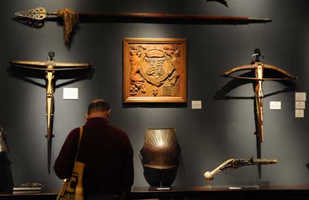 Visitors look at ancient arms of Europe during the 22nd European Fine Art Fair TEFAF Maastricht 09, in Maastricht, Netherlands, March 15, 2009.[Wu Wei/Xinhua]