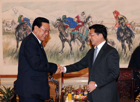 Visiting Premier of the Democratic People's Republic of Korea (DPRK) Kim Yong Il (L) shakes hands with Chinese Assistant Foreign Minister Hu Zhengyue in Beijing March 17, 2009. [Rao Aimin/Xinhua]