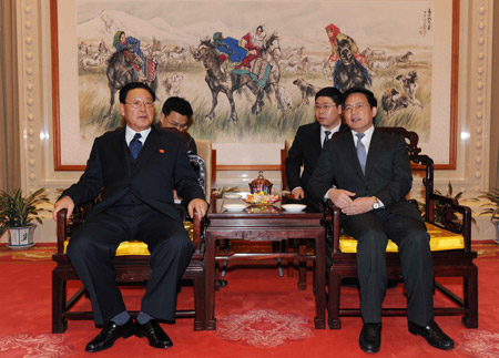 Visiting Premier of the Democratic People's Republic of Korea (DPRK) Kim Yong Il (L) talks with Chinese Assistant Foreign Minister Hu Zhengyue in Beijing March 17, 2009. [Rao Aimin/Xinhua] 