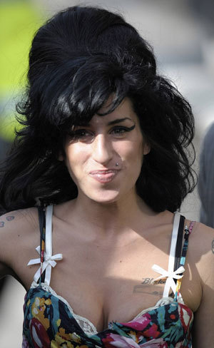 British singer Amy Winehouse leaves the City of Westminster Magistrates Court in central London March 17, 2009. Winehouse appeared in court on Tuesday and denied a charge of assaulting a woman after a charity ball in London last year. [Xinhua/Reuters]