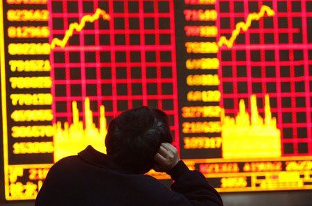 A man monitors an electronic screen showing stock information at a brokerage house in Shanghai March 17, 2009. [Chian Daily/Agencies]