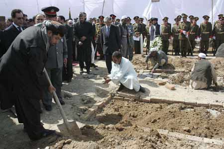 The governor of Nangahar province Gul Agha Sherzai (L) attends the ceremony of the reburial of the remains of Afghanistan's first president Mohammad Daud Khan, and his brother Naeem Khan, during a ceremony in Kabul March 17, 2009. Daud Khan's remains and those who were killed with him were found at a mass grave recently. [Xinhua/Reuters]