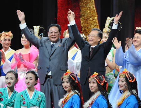 Chinese Premier Wen Jiabao (2nd R, 2nd Line) and his counterpart of the Democratic People's Republic of Korea (DPRK) Kim Yong Il (3rd L, 2nd Line) wave as they pose for a group photo with performers after the performance for the launch of the China-DPRK Friendship Year in Beijing, capital of China, March 18, 2009.[Xinhua] 