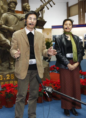 Zhang Yun (L) and Degyi Zhoema, researchers of the Tibetology Research Center of China, answer questions from foreign correspondents at the '50th Anniversary of Democratic Reforms in Tibet' Exhibition in Beijing, capital of China, March 18, 2009. A number of foreign journalists, organized by the Information Department of China's Foreign Ministry, visited the exhibition on Wednesday. [Li Mingfang/Xinhua]