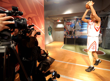 Photographers take photos of the lifesize wax figure of Yao Ming, the most popular and beloved basketball player in both China and the United States, at Madame Tussauds in New York of the United States, March 18, 2009. On loan from Madame Tussauds Shanghai for six months, Yao's wax figure made its debut in Madame Tussauds New York on Wednesday. [Shen Hong/Xinhua] 