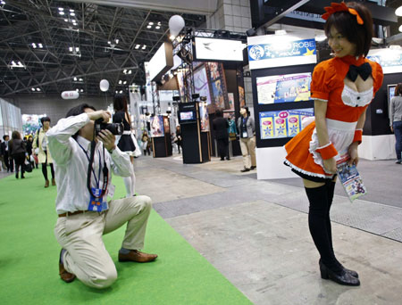 A model wearing an animation character's costume poses for a visitor at Tokyo International Anime Fair 2009 in Tokyo March 18, 2009. The fair, into its eighth year goes on until March 21.[Xinhua/Reuters]