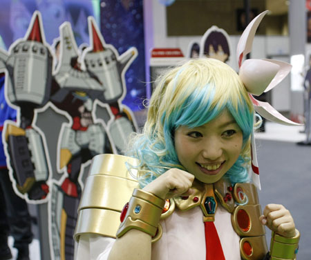 A model in an animation character's costume poses for a visitor at Tokyo International Anime Fair 2009 in Tokyo March 18, 2009.[Xinhua/Reuters]