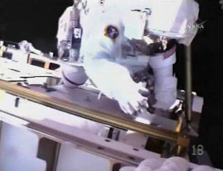 Astronaut Steve Swanson is seen in this view from the helmet camera of fellow spacewalker Richard Arnold as the pair work to install the International Space Station's new truss assembly and solar array in this image from NASA TV March 19, 2009. [Xinhua/Reuters]
