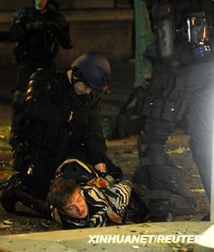 French riot police arrest a youth at the end of a peaceful protest march in Paris March 19, 2009. Several hundred youths clashed with police in Paris on Thursday, as peaceful, million-strong protests against France's handling of the economic crisis turned violent.[Xinhua/AFP] 