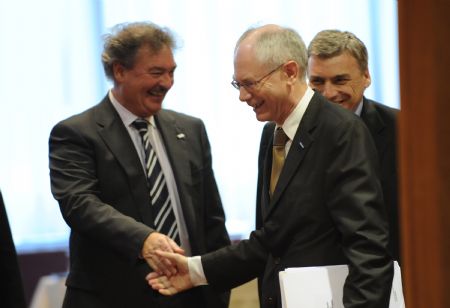 Belgian Prime Minister Herman Van Rompuy (R, front) shakes hands with Luxembourg Foreign Minister Jean Asselborn during the first day meeting of EU spring summit in Brussels, capital of Belgium, March 19, 2009. [Wu Wei/Xinhua]