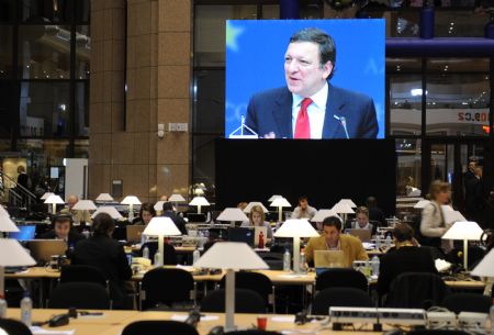 European Commission's President Jose Manuel Barroso (shown on the screen) speaks during the press conference after the first day meeting of EU spring summit in Brussels, capital of Belgium March 19, 2009. 