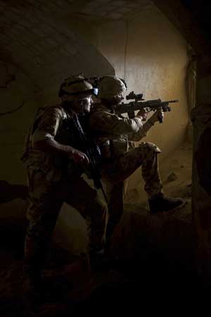 In this image released in London by the Royal Navy, Thursday March 19, 2009, Royal Marines from Britain's 42 Commando Group take up a position in the southern-most regions of Helmand Province, Afghanistan, Wednesday March 4, 2009, during a mission to provide critical information and intelligence for subsequent operations, in an area never before visited in such strength. [Xinhua/Reuters]