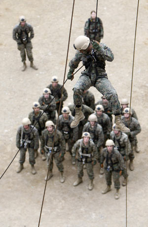 A member of the U.S. Marine Corps Fleet Antiterrorism Security Team Pacific, comprising of 46 marines from a military base in Norfolk, Virginia and deployed currently to Japan's Yokosuka, conducts a mountain warfare drill in Pohang, about 370 km (230 miles) southeast of Seoul, Mar. 20, 2009. [Xinhua/Reuters]