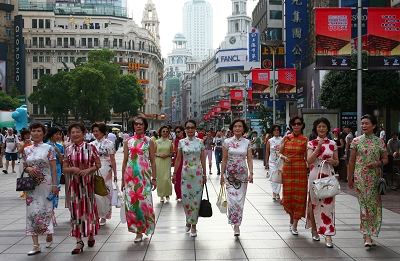 Members of a local qipao club, dressed in qipao, walk on a street to show the traditional Chinese styles. They will take their favorite dresses to Taiwan to promote the World Expo 2010 there [Oriental Morning Post]