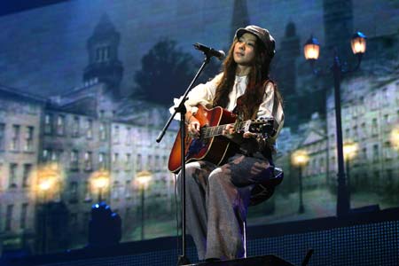 Cheer Chen, a singer from southeast China's Taiwan province, sings with the guitar during her concert held at the Shanghai Grand Stage in Shanghai, east China, March 20, 2009. Chen held an extra concert to thank her fans in Shanghai on Friday. [Xinhua]