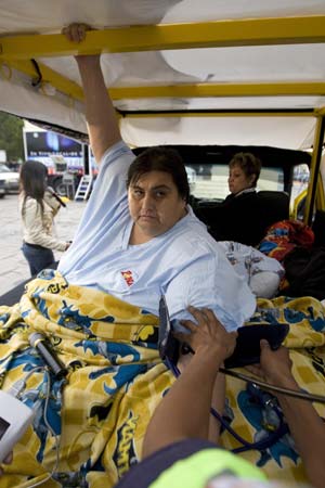 A paramedic checks the blood pressure of Manuel Uribe before a TV interview in his new modified truck in the suburb of San Nicolas de los Garza, in Monterrey March 20, 2009. 