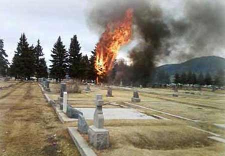 In this picture provided by Martha Guidoni via The Montana Standard, a fire burns inside the Holy Cross Cemetery after a small, singe-engine plane crashed in an area just south of the Bert Mooney Airport in Butte, Mont. on Sunday, March 22, 2009. 