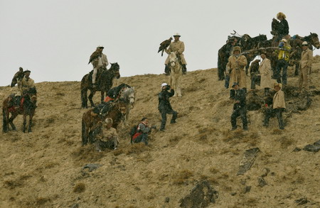 Kirgiz herders display their falcons to photographers during the Second Falcon Cultural Festival in Akqi county, northwest China's Xinjiang Uygur autonomous region on March 21, 2009. [Xinhua]