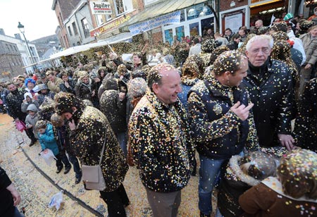 Peopel are covered by confetti during carnival parade in Stavelot, about 150 kilometers east of Brussels, capital of Belgium, March 22, 2009. Carnival celebrations in Stavelot reached climax Sunday, while 'Blanc Moussi' flogged crowds with pork bladders and threw confetti to them. [Wu Wei/Xinhua] 