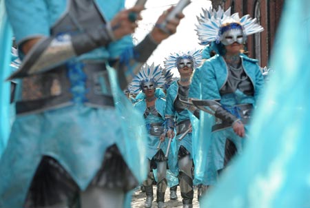 Colourful dressed Revellers dance during carnival parade in Stavelot, about 150 kilometers east of Brussels, capital of Belgium, March 22, 2009. Carnival celebrations in Stavelot reached climax Sunday, while 'Blanc Moussi' flogged crowds with pork bladders and threw confetti to them. [Wu Wei/Xinhua]