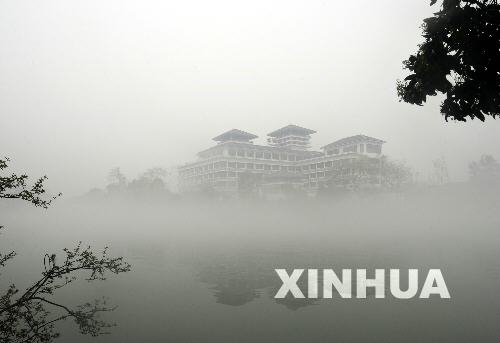 Buildings are shrouded in fog in Guilin City, Guangxi Zhuang Automonous Region March 20, 2009.