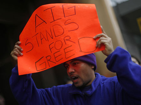  A protestor takes part in a rally in front of an American International Group (AIG) office calling on Congress to take action on employee free choice, health care, and banking reform in Washington, March 19, 2009.[Xinhua/Reuters]