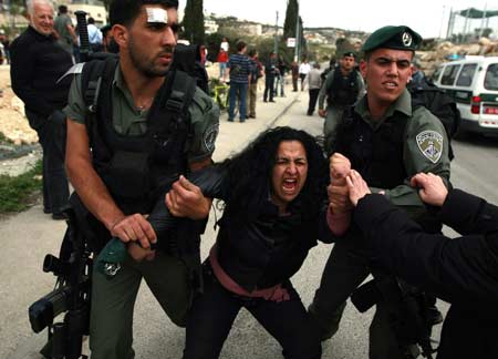 Israeli border police officers detain a Palestinian woman in east Jerusalem March 23, 2009, during an event marking Jerusalem's tenure as the Arab League's 'capital of Arab culture' for 2009. According to an Israeli police spokesperson, several activists were detained as the police dispersed an illegal gathering.[Xinhua/Reuters]