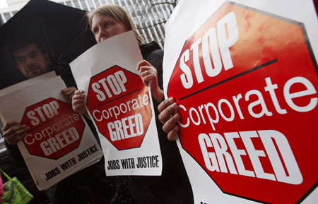  Protestors gather out in front of an American International Group (AIG) office during a rally calling on Congress to take action on employee free choice, health care, and banking reform in Washington, March 19, 2009. [Xinhua/Reuters]