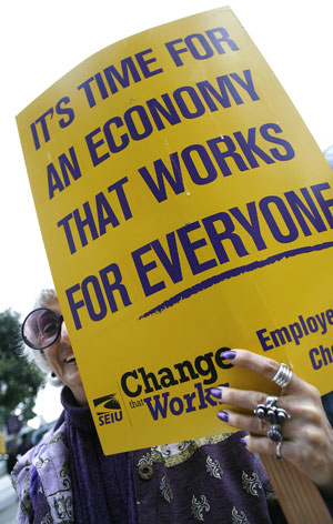 Luise Monaco takes part in a protest outside the AIG building in Los Angeles March 19, 2009. The action was part of a national protest against major U.S. banks and firms with participants calling on Congress to take action on employee free choice, health care, and banking reform. [Xinhua/Reuters]