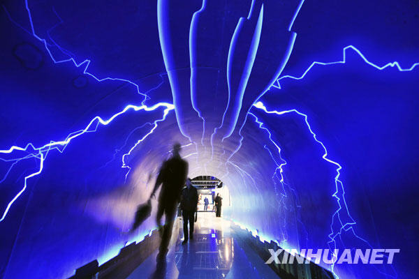 Visitors walk through the Thunderbolt Passage to experience the power of the nature, inside the Meteorologic Popular Science Hall for Public Experience, which opens to mark the World Meteorological Day, in Hangzhou, capital of east China's Zhejiang Province, March 23, 2009. 