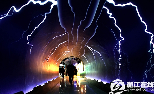 Visitors walk through the Thunderbolt Passage to experience the power of the nature, inside the Meteorologic Popular Science Hall for Public Experience, which opens to mark the World Meteorological Day, in Hangzhou, capital of east China's Zhejiang Province, March 23, 2009. 