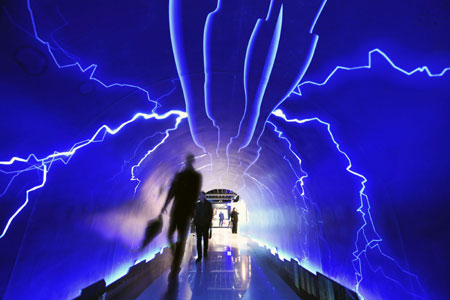 Visitors walk through the Thunderbolt Passage to experience the power of the nature, inside the Meteorologic Popular Science Hall for Public Experience, which opens to mark the World Meteorological Day, in Hangzhou, capital of east China's Zhejiang Province, March 23, 2009. Visitors came here to learn about popular ken of sciences, weather phenomena, catastrophic accidents, and others in close relevance to meteorology, as well as interact with meteorology-related activities. [Li Zhong/Xinhua] 