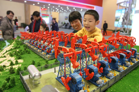 Visitors view energy-saving defueling pump models during the China International Energy Saving, Emission Reduction and New Energy Science and Technology Expo at the Beijing Exhibition Center in Beijing, capital of China, March 22, 2009. [Chen Xiaogen/Xinhua] 