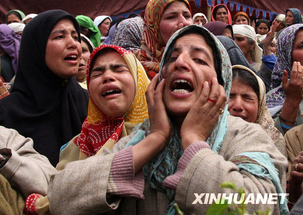 Women cry during the funeral of Shabir Ahmad Malik, a Kashmiri Muslim soldier of the Indian army, in Dab, 35 kilometers north of Srinagar, summer capital of Indian-controlled Kashmir, March 24, 2009. 