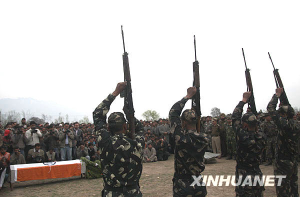 Indian army soldiers prepare to fire into the air during the funeral of Shabir Ahmad Malik, a Kashmiri Muslim soldier of the Indian army, in Dab, 35 kilometers north of Srinagar, summer capital of Indian-controlled Kashmir, March 24, 2009. 