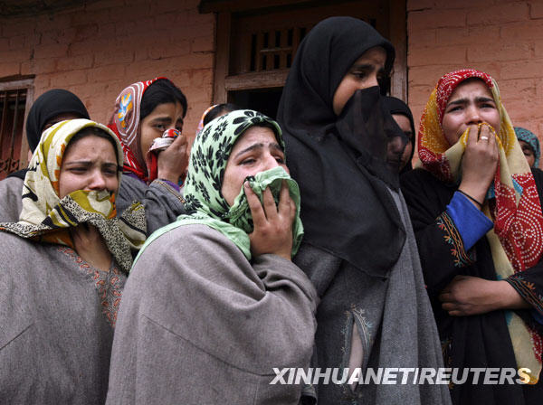 Women cry during the funeral of Shabir Ahmad Malik, a Kashmiri Muslim soldier of the Indian army, in Dab, 35 kilometers north of Srinagar, summer capital of Indian-controlled Kashmir, March 24, 2009. 