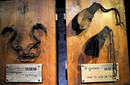 Photo taken on March 22, 2009 shows fetter and face-lash whips on display at the Zhol City prison site at the foot of the Potala Palace. [Xinhua Photo]
