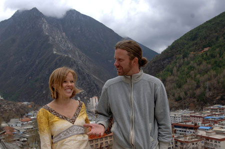 Owner of newly finished Tibetan-style Zhilam Hostel Kristopher Rubesh (R) and his wife Stephanie Rubesh (L) talk outside their hostel in Kangding, the Tibetan Autonomous Prefecture of Garze, southwest China's Sichuan Province, March 23, 2009. 