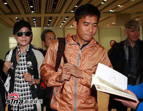 Celebrity couple Tony Leung and Carina Lau arrive at Beijing's Capital International Airport on Tuesday March 24, for the Wednesday premiere of director Wang Kar-Wai's 'Ashes of Time: Redux.'