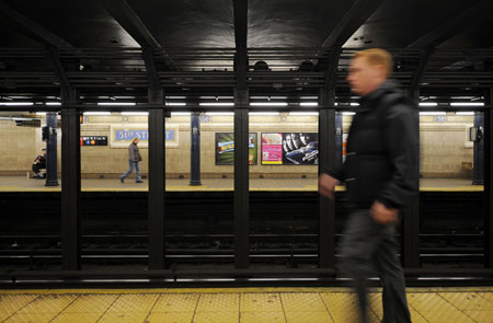 A passenger walks on the subway platform in New York, the United States, March 24, 2009. [Gu Xinrong/Xinhua]