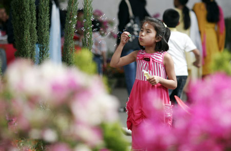 A Nepali young girl blows soap bubbles while visiting the 12th Floriculture Trade Festival-2009 in Kathmandu, capital of Nepal, on March 25, 2009. The five-day Festival started in Kathmandu on Wednesday. [Bimal Gautam/Xinhua]