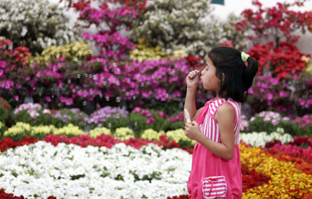 A Nepali young girl blows soap bubbles while visiting the 12th Floriculture Trade Festival-2009 in Kathmandu, capital of Nepal, on March 25, 2009. The five-day Festival started in Kathmandu on Wednesday. [Bimal Gautam/Xinhua]