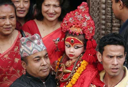 Relatives carry the Living Goddess Kumari (C), as she is brought to witness of the Ghode Jatra or Horse Racing Festival in Kathmandu, capital of Nepal, on March 26, 2009. [Xinhua]