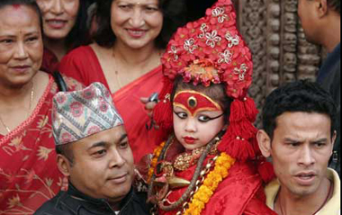 Relatives carry the Living Goddess Kumari (C), as she is brought to witness of the Ghode Jatra or Horse Racing Festival in Kathmandu, capital of Nepal, on March 26, 2009. [Xinhua]