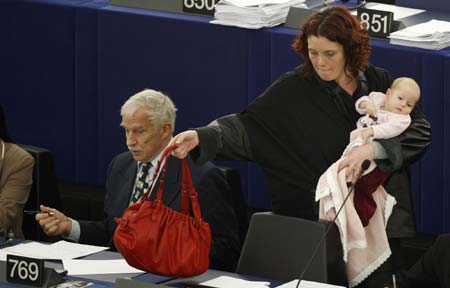 Denmark's member of the European Parliament Hanne Dahl (R) arrives with her baby to take part in a voting session at the European Parliament in Strasbourg March 26, 2009.[Xinhua/Reuters]