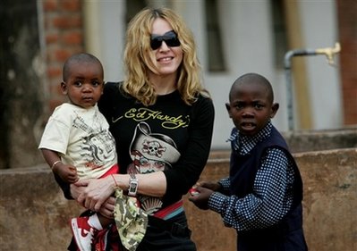 Madonna holds David Banda in her arms, in this April 19, 2007, file photo at Consol Homes, a day care center that she is funding in the village of Masekese, Malawi. 